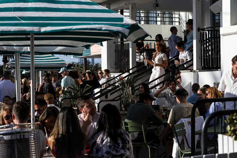 People gather at the Hotel Esplanade along Fitzroy Street in St Kilda, Melbourne.