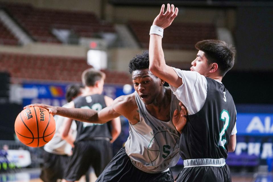 Sunnyslope forward Jai Anthoni Bearden (12), at left, is guarded by Sunnyslope guard Dom Rojas (2) during a media day practice at the Arizona Veterans Memorial Coliseum on Friday, March 3, 2023, in Phoenix. 