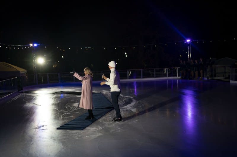 First lady Jill Biden speaks about children's "magic, wonder and joy," during the holidays as U.S. Olympic and World Champion Brian Boitano looks on during the opening of the White House Holiday Ice Rink on the South Lawn of the White House. Photo by Bonnie Cash/UPI