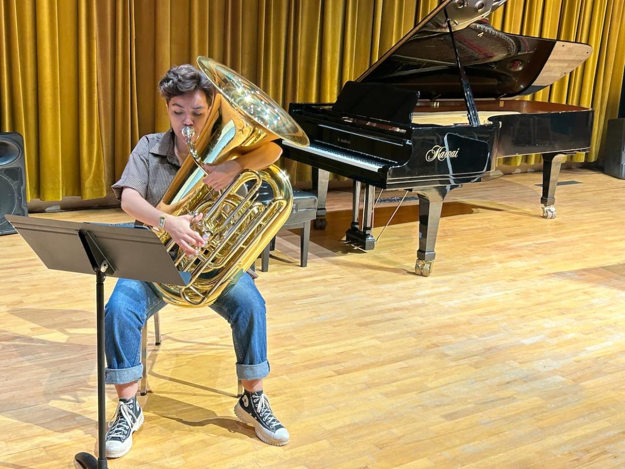 Olive MacPhail hones her tuba skills on the performance stage of Memorial University's music school. (Ife Alaba/CBC - image credit)