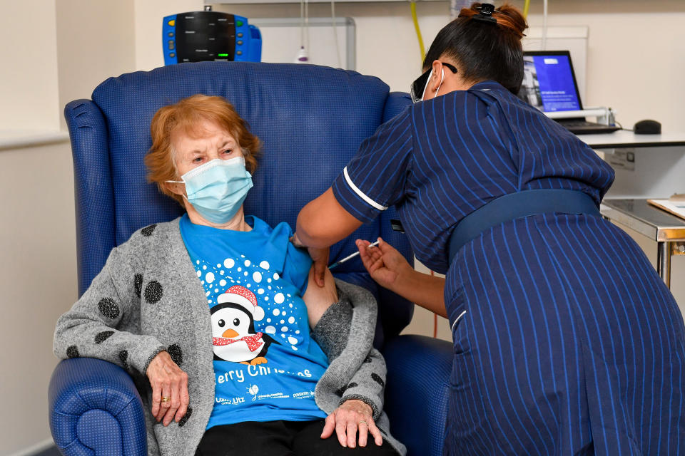 Nurse May Parsons (R) administers the Pfizer/BioNtech Covid-19 vaccine to Margaret Keenan (L), 90, at University Hospital in Coventry, central England, on December 8, 2020 making Keenan the first person to receive the vaccine in the country's biggest ever immunisation programme. - Britain on December 8 hailed a turning point in the fight against the coronavirus pandemic, as it begins the biggest vaccination programme in the country's history with a new Covid-19 jab. (Photo by Jacob King / POOL / AFP) / The erroneous mention[s] appearing in the metadata of this photo by Jacob King has been modified in AFP systems in the following manner: Pictures were taken on [December 8, 2020] instead of [December 9, 2020]. Please immediately remove the erroneous mention[s] from all your online services and delete it (them) from your servers. If you have been authorized by AFP to distribute it (them) to third parties, please ensure that the same actions are carried out by them. Failure to promptly comply with these instructions will entail liability on your part for any continued or post notification usage. Therefore we thank you very much for all your attention and prompt action. We are sorry for the inconvenience this notification may cause and remain at your disposal for any further information you may require. (Photo by JACOB KING/POOL/AFP via Getty Images)