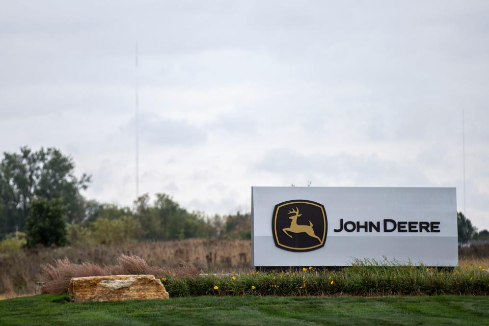 Workers manufacture heavy agricultural equipment at John Deere's Ankeny location.