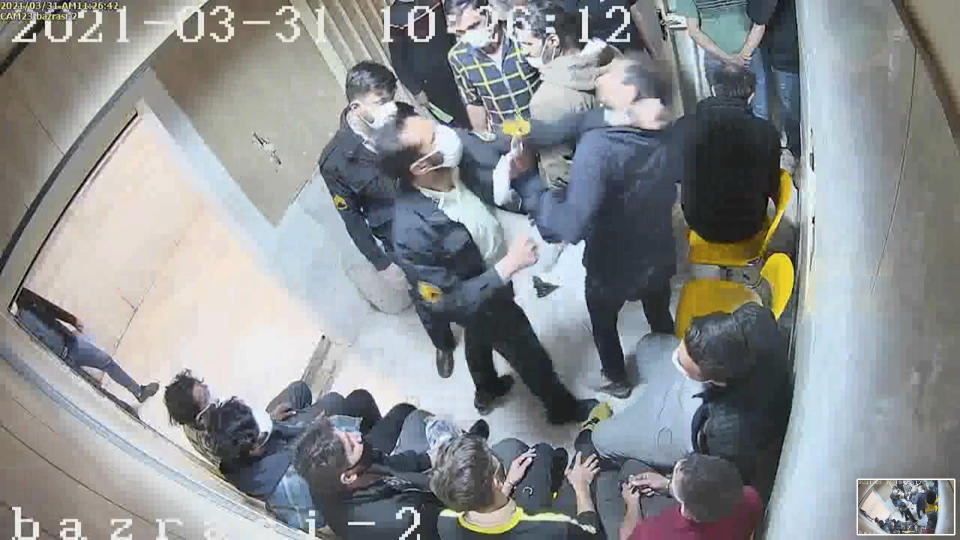 In this undated frame grab taken from video shared with The Associated Press by a self-identified hacker group called "The Justice of Ali," a guard beats a prisoner, at Evin prison in Tehran, Iran. The alleged hackers said the release of the footage was an effort to show the grim conditions at the prison, known for holding political prisoners and those with ties abroad who are often used as bargaining chips in negotiations with the West. (The Justice of Ali via AP)