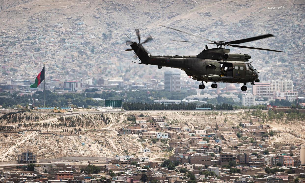 <span>An RAF Puma helicopter flies over Kabul. The Puma and CH-47 Chinook, cited in the legal action, remain in service.</span><span>Photograph: UK Ministry of Defence/Getty Images</span>