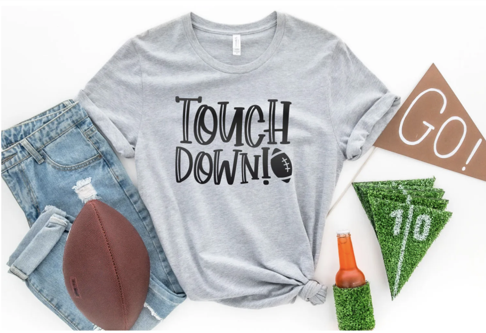 <p>Get your crew ready for the game with these graphic t-shirts. It also makes a great freebie for them to take home and remember the fun-filled day. </p><p><a href="https://heyletsmakestuff.com/touchdown-svg/" rel="nofollow noopener" target="_blank" data-ylk="slk:Get the tutorial at Hey Let's Make Stuff! »;elm:context_link;itc:0;sec:content-canvas" class="link "><em>Get the tutorial at Hey Let's Make Stuff! »</em></a></p>