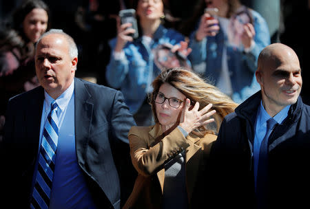 FILE PHOTO: Actor Lori Loughlin, facing charges in a nationwide college admissions cheating scheme, is escorted to federal court in Boston, Massachusetts, U.S., April 3, 2019. REUTERS/Brian Snyder