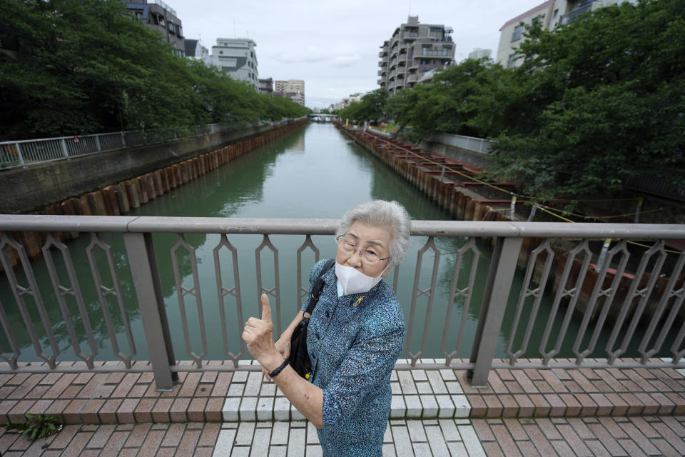 Kisako Motoki, who lost her parents and siblings to the Great Tokyo Air Raid on March 10, 1945, speaks on her war experience at Kikukawa Bridge where she escaped from air raid bombing in Tokyo Wednesday, July 29, 2020. In Japan, war orphans were punished for surviving. They were bullied. They were called trash, sometimes rounded up by police and put in cages. Some were sent to institutions or sold for labor. They were targets of abuse and discrimination. Now, 75 years after the war's end, some are revealing their untold stories of recovery and pain, underscoring Japan’s failure to help its own people. (AP Photo/Eugene Hoshiko)