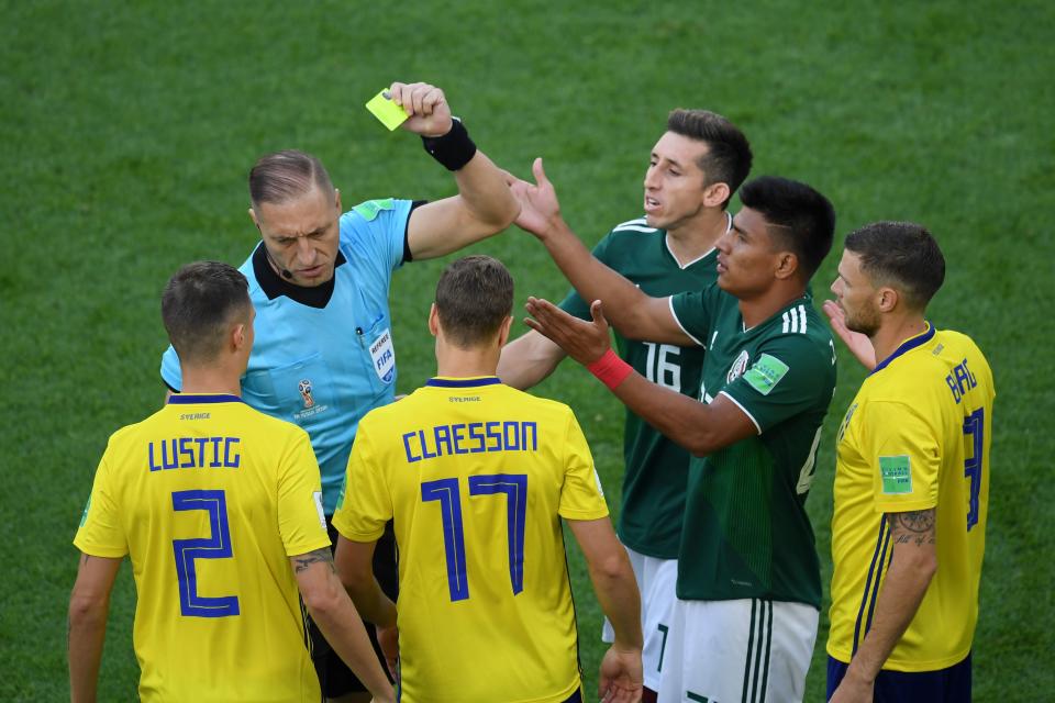 Mexico’s defender Jesus Gallardo is shown a yellow card by Argentine referee Hernan Maidana during the Russia 2018 World Cup Group F football match between Mexico and Sweden at the Ekaterinburg Arena in Ekaterinburg on June 27, 2018. (Getty Images)