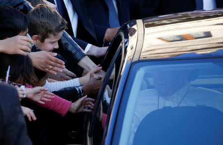 Pope Francis (R) waves from his car as he leaves after his visit at the Basilica of Saint Bartholomew on Tiber island in Rome, April 22, 2017. REUTERS/Alessandro Bianchi