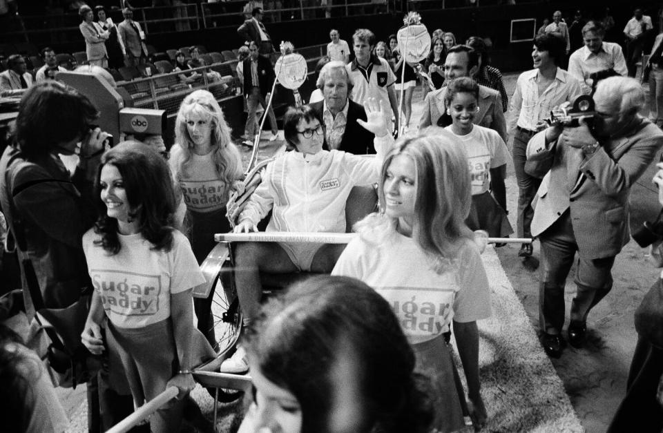 Bobby Riggs, riding in a rickshaw, makes his grand entrance into the Houston Astrodome.