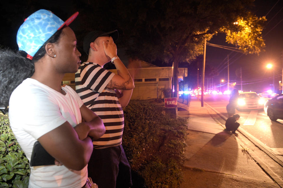 <p>Jermaine Towns, left, and Brandon Shuford wait down the street from a multiple shooting at a nightclub in Orlando, Fla., Sunday, June 12, 2016. Towns said his brother was in the club at the time. A gunman opened fire at a nightclub in central Florida, and multiple people have been wounded, police said Sunday. (AP Photo/Phelan M. Ebenhack) </p>