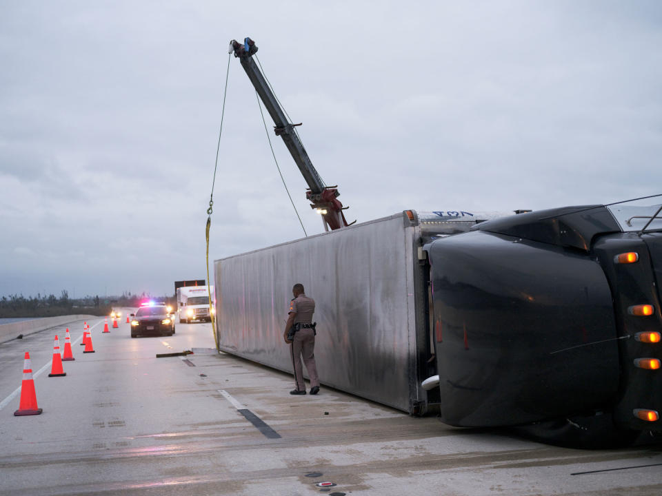 A semi-trailer turned over by Hurricane Ian's strong winds blocks a stretch of the the Albert W. Gilchrist Bridge between Port Charlotte and Punta Gorda, Fla.<span class="copyright">Christopher Morris for TIME</span>