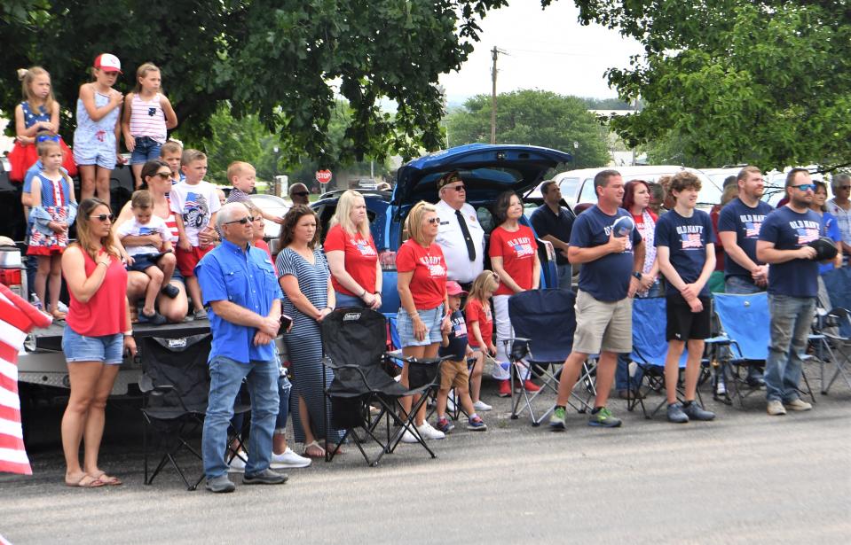 Guests stand for the pledge of allegiance during a Memorial Day ceremony in Windthorst on Monday, May 29, 2023.
