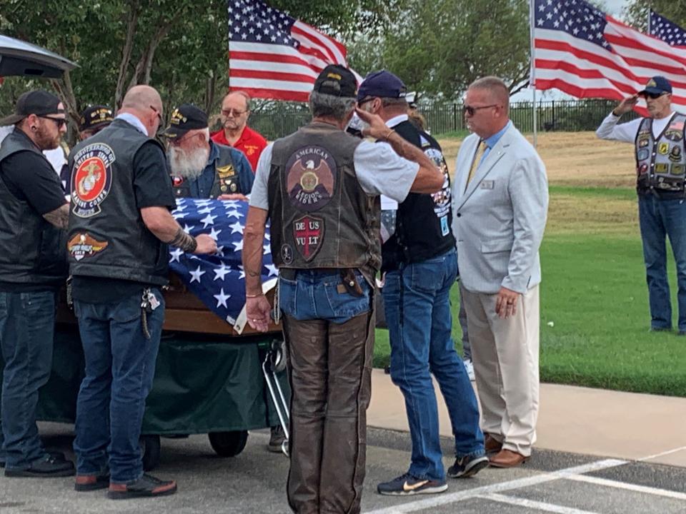Members of the American Legion Riders salute the unaccompanied veteran, Bob G. Wood, as his casket exits a vehicle inside the Texas State Veterans Cemetery at Abilene on July 29, 2024.