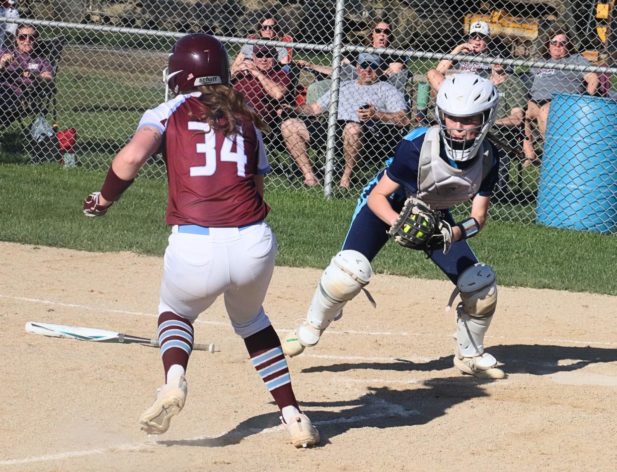 Prairie Central catcher Lydia Kilgus gets Chayse Palmer of St. Joseph-Ogden to change direction on a play at the plate.