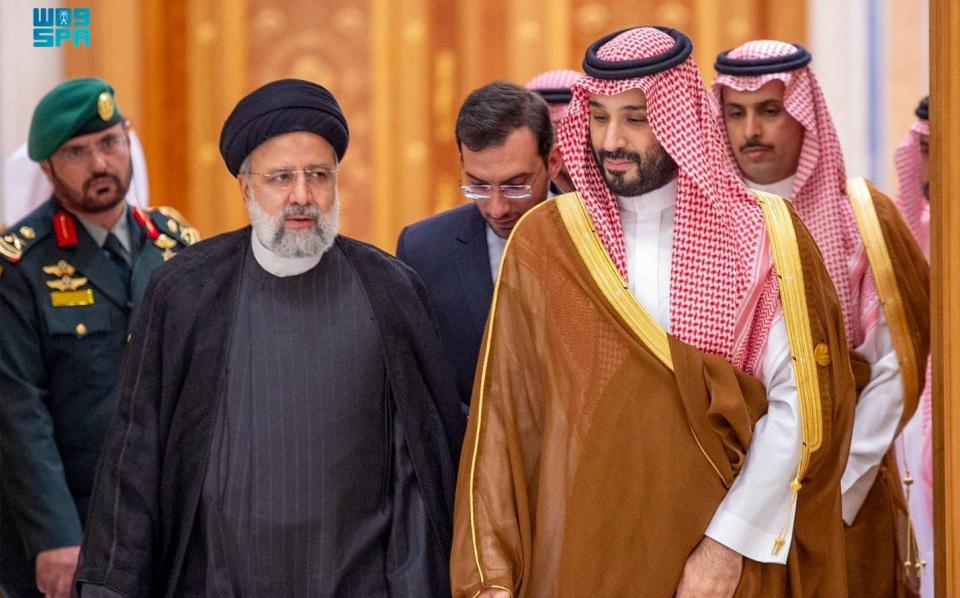 Saudi Crown Prince Mohammed bin Salman (R) and Iran's president Ebrahim Raisi (L) attend an emergency meeting of the Arab League and the Organisation of Islamic Cooperation