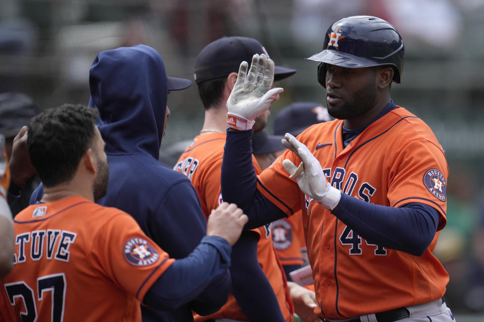 Houston Astros' Yordan Alvarez, right, is congratulated by teammates after hitting a home run during the ninth inning of a baseball game against the Oakland Athletics in Oakland, Calif., Sunday, May 28, 2023. (AP Photo/Jeff Chiu)