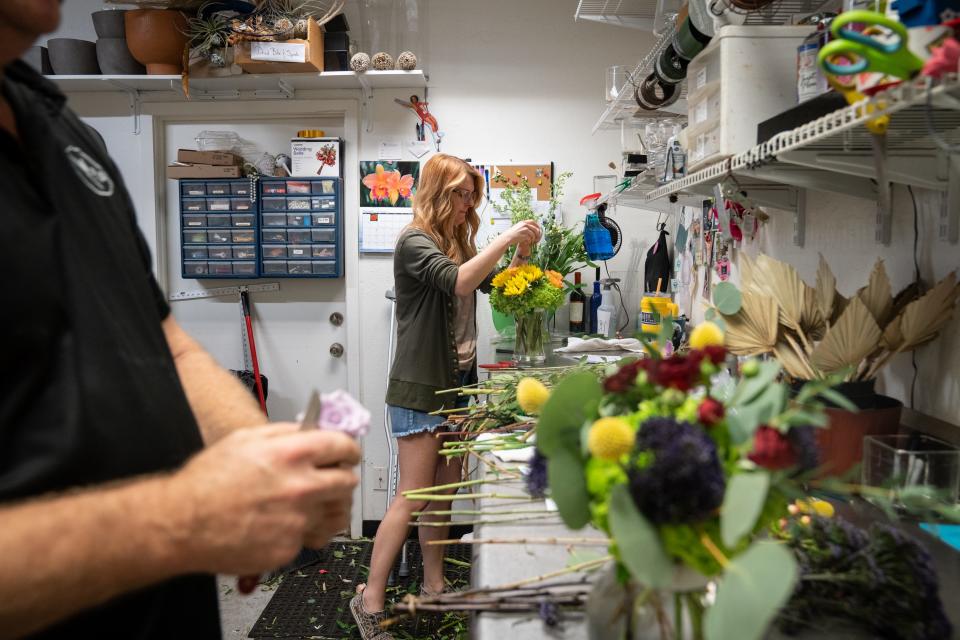 Bre Schindler, PJ's Flowers & Events manager, works on an arrangement at PJ's Flowers & Events on November 6, 2023, in Phoenix, Arizona.
