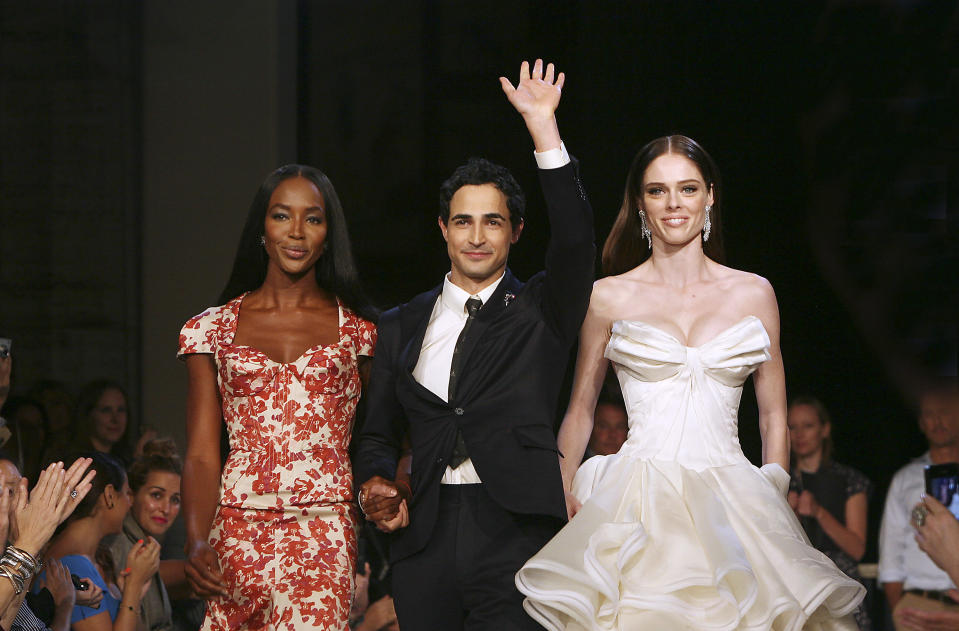 Models Naomi Campbell, left, and Coco, right, walk with designer Zac Posen at the Zac Posen Spring 2013 Runway Show on Sunday, Sept. 9, 2012 in New York. (Photo by Amy Sussman/Invision/AP Images)