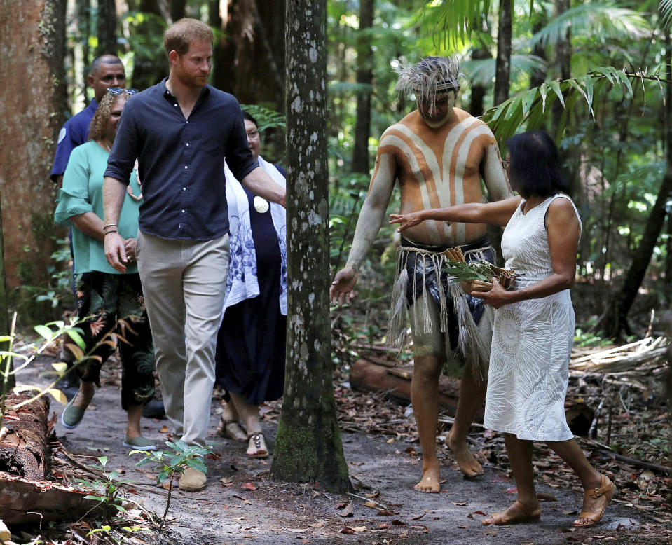 Britain's Prince Harry, the Duke of Sussex, front left, attends a dedication ceremony of the forests of K'gari to the Queen's Commonwealth Canopy on Fraser Island, Queensland, Australia Monday, Oct. 22, 2018. The Duke and Duchess of Sussex took separate boats Monday to Queensland's Fraser Island as their tour of Australia and the South Pacific continued with a reduced schedule for the pregnant duchess. (Phil Noble/Pool Photo via AP)