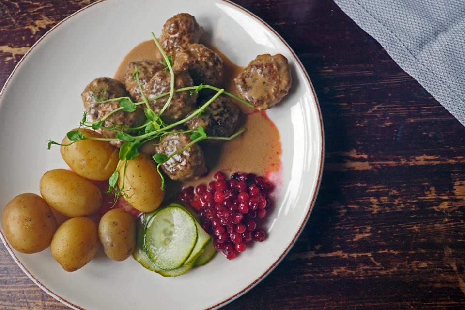 A plate of Swedish meatballs with potatoes and berry jam