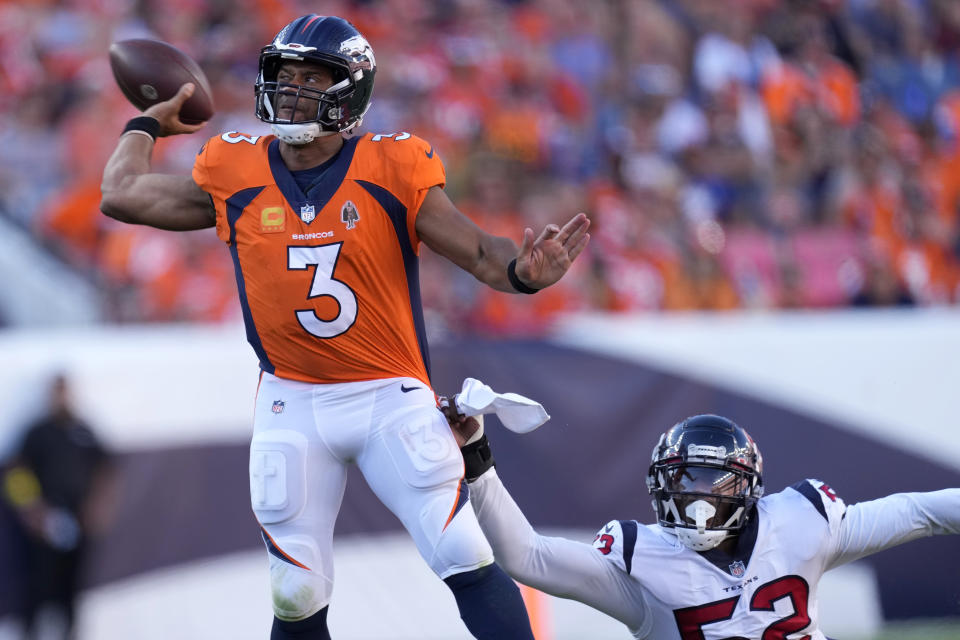 Denver Broncos quarterback Russell Wilson (3) is pressured by Houston Texans defensive end Jonathan Greenard (52) during the second half of an NFL football game, Sunday, Sept. 18, 2022, in Denver. (AP Photo/David Zalubowski)