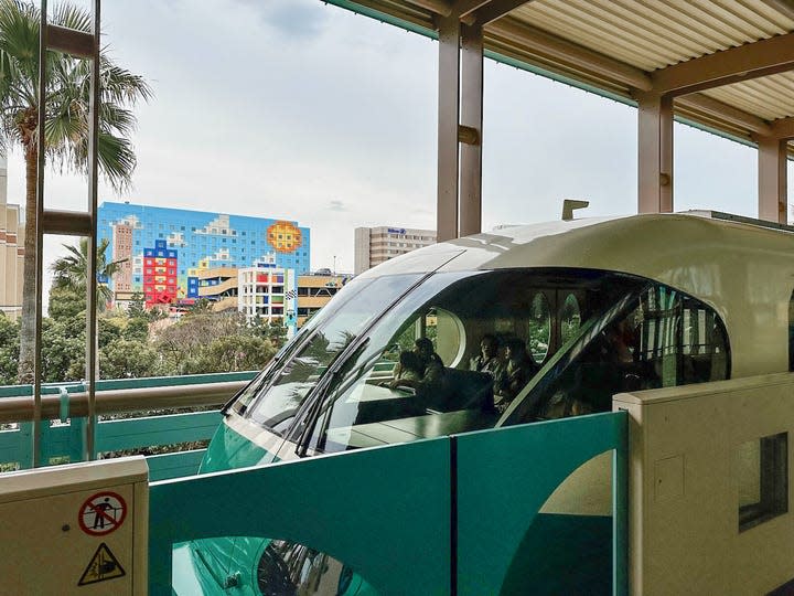 The Disney Resort Line, shown in aqua and white, stops outside of the Toy Story Hotel.