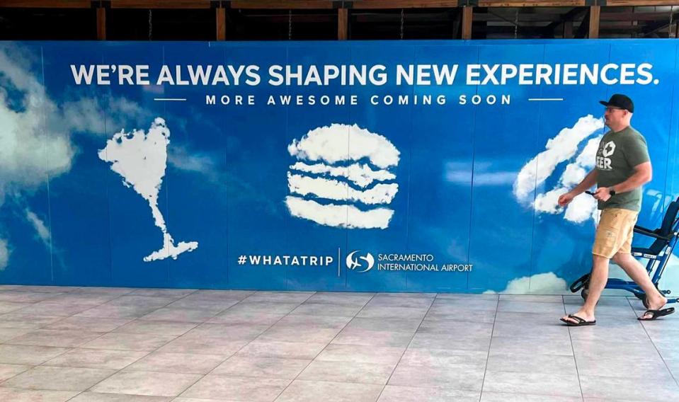 A man walks past a sign alluding to a remake of the airport’s concession program at the Sacramento International Airport. Officials plan farm-to-folk options, Asian eateries and more budget friendly choices.