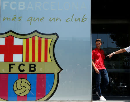 Soccer player Denis Suarez arrives to pose in front of a FC Barcelona's giant logo at their offices in Barcelona, Spain, July 5, 2016. REUTERS/Albert Gea