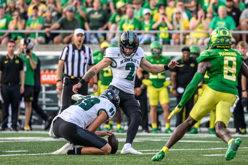 Sep 16, 2023; Eugene, Oregon, USA; Hawaii Warriors place kicker Matthew Shipley (2) kicks a field goal from the hold of place kicker Ben Falck (69) against the Oregon Ducks during the second half at Autzen Stadium. Mandatory Credit: Craig Strobeck-USA TODAY Sports