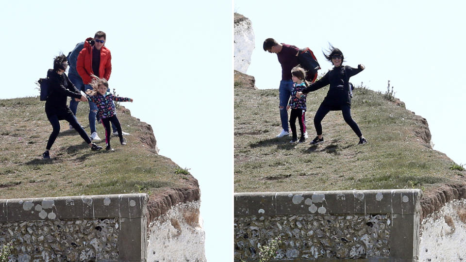 A woman spots the potential danger and pulls the girl back from the edge near Birling Gap, Eastbourne.