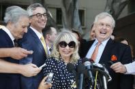 Shelly Sterling, 79, (2nd R) speaks at a news conference with her lawyer Pierce O'Donnell (R) and Steve Ballmer's lawyer Adam Streisand (2nd L) in Los Angeles, California July 28, 2014. The record $2 billion sale of pro basketball's Los Angeles Clippers to former Microsoft Corp chief executive Steve Ballmer can proceed over the objections of co-owner Donald Sterling, a judge tentatively ruled on Monday. Los Angeles Superior Court Judge Michael Levanas said the deal, brokered by Sterling's estranged wife, Shelly Sterling, was permissible and could be consummated even if Sterling, who has been banned for life from the NBA for racist remarks, chose to appeal. REUTERS/Lucy Nicholson (UNITED STATES - Tags: CRIME LAW SPORT BASKETBALL TPX IMAGES OF THE DAY)