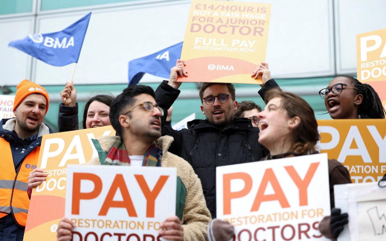 People attend a protest in London by junior doctors, amid a dispute with the government over pay - May James/Reuters