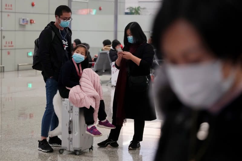 Passengers wearing masks are seen at Hongqiao International Airport in Shanghai