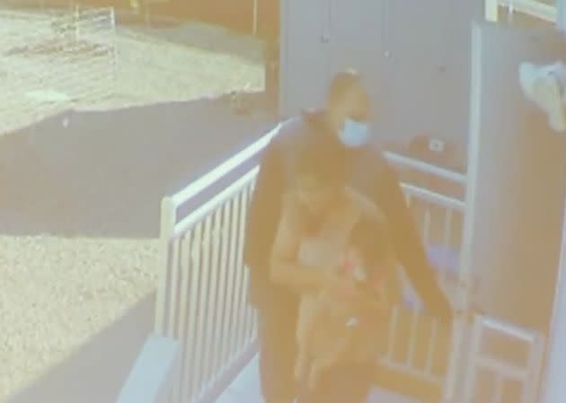 Surveillance video captured the family being escorted out of the business at gunpoint. Jasleen Kaur is seen carrying her daughter. (Photo: Merced County Sheriff's Office)