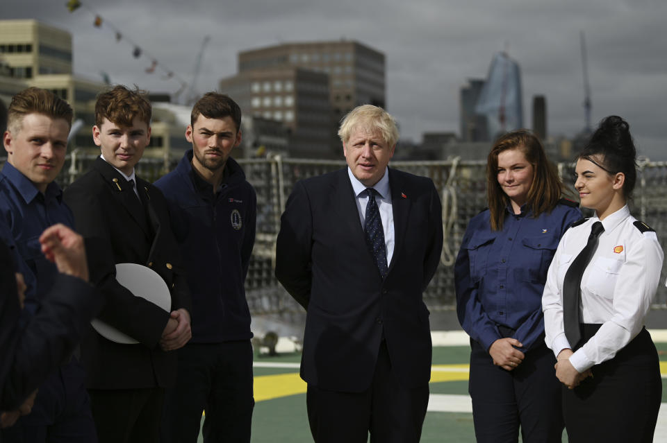 Britain's Prime Minister Boris Johnson speaks to apprentices as he visits the NLV Pharos, a lighthouse tender moored on the river Thames, to mark London International Shipping Week in London, Thursday, Sept. 12, 2019. The British government insisted Thursday that its forecast of food and medicine shortages, gridlock at ports and riots in the streets after a no-deal Brexit is an avoidable worst-case scenario, as Prime Minister Boris Johnson denied misleading Queen Elizabeth II about his reasons for suspending Parliament just weeks before the country is due to leave the European Union. (Daniel Leal-Olivas/Pool photo via AP)