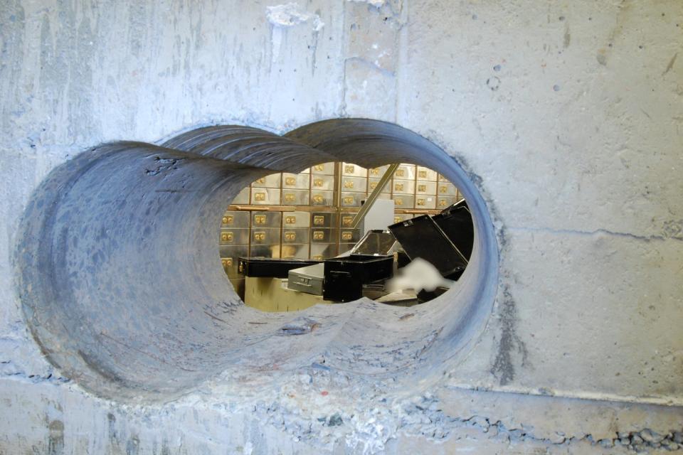 Hole in the wall: The gap the raiders crawled through to access the vault in the Hatton Garden raid (Metropolitan Police)