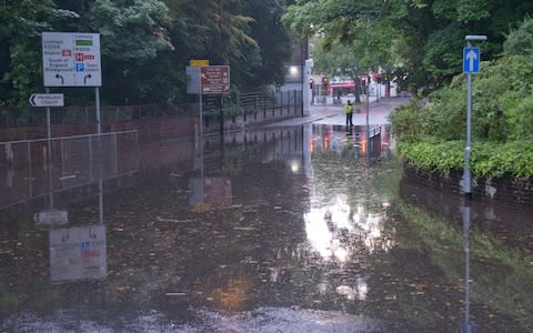 Police at the scene of a flooded road in Haywards Heath, Sussex - Credit: Eddie Howland/Solent News