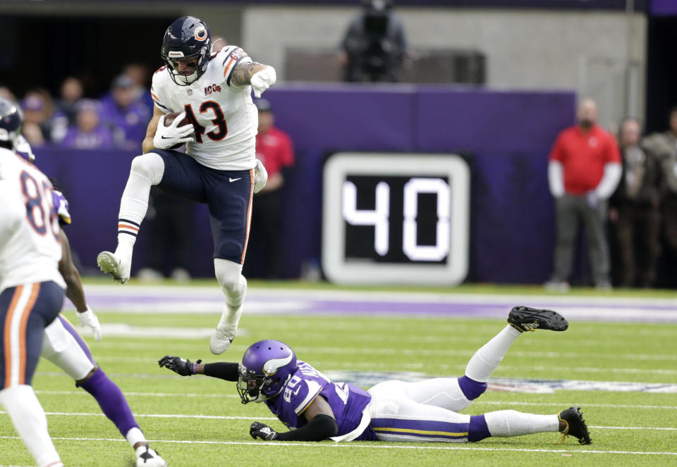 Chicago Bears tight end Eric Saubert (43) leaps over Minnesota Vikings cornerback Mackensie Alexander, right, during the first half of an NFL football game, Sunday, Dec. 29, 2019, in Minneapolis. (AP Photo/Andy Clayton-King)