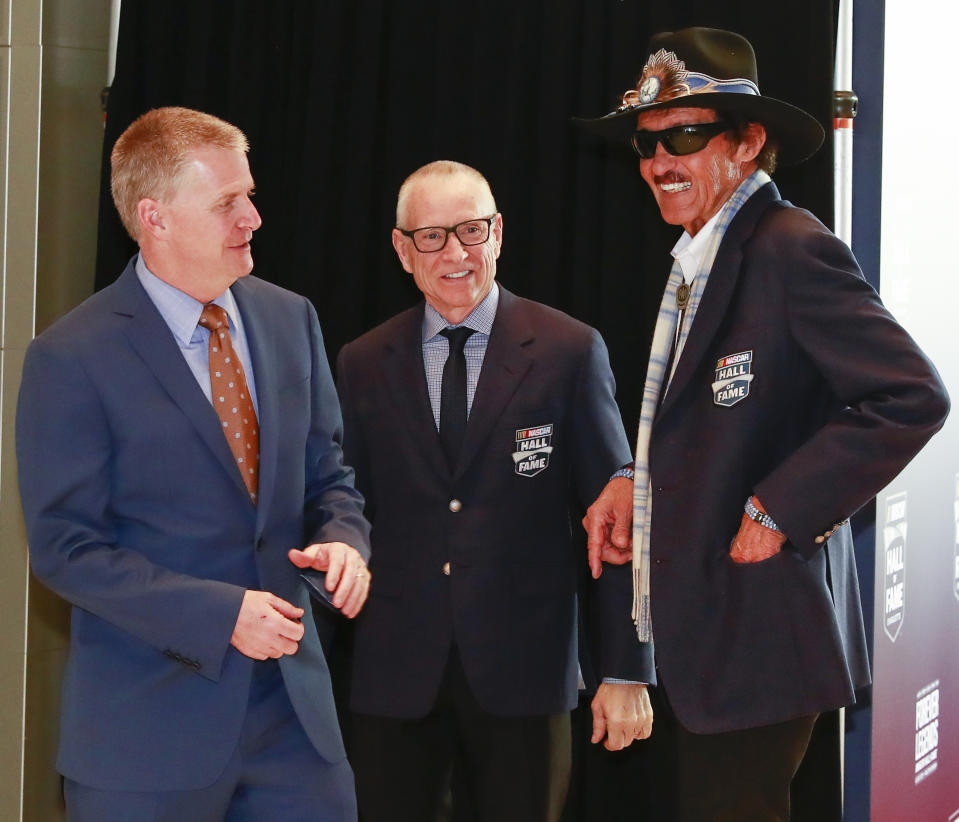 Former NASCAR drivers from left to right, Jeff Burton, Mark Martin and Richard Petty have a conversation on the red carpet before the NASCAR Hall of Fame induction ceremony for the Class of 2019, Friday, Feb. 1, 2019, in Charlotte, N.C. (AP Photo/Jason E. Miczek)
