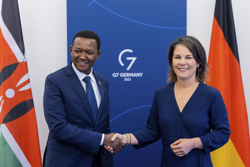 The Foreign Minister of the Republic of Kenya, Alfred Mutua, left, and German Foreign Minister Annalena Baerbock, right, shake hands during a meeting as part of the G7 Foreign Ministers Meeting in Muenster, Germany, Friday, Nov. 4, 2022. (Rolf Vennenbernd/DPA via AP, Pool)