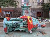 <p>The toppled statue of Egerton Ryerson, one of the architects of indigenous boarding school system, is laying on its side in Toronto on June 6, 2021. (Photo by OLIVIER MONNIER/AFP via Getty Images)</p> 