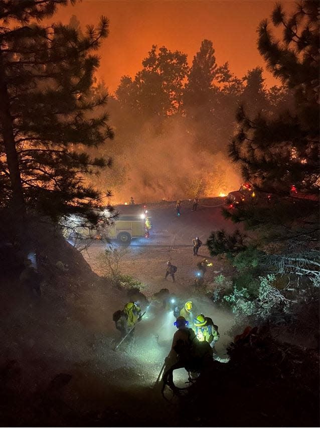 In this handout photo obtained from the San Francisco Fire Department on September 11, 2022, firefighters from the San Francisco Fire Department work to put out flames from the Mosquito Fire, outside of Sacramento, California.