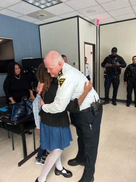 Fayetteville Police Maj. Christopher Todd Joyce hugs Louisiana teen Roslyn Baldwin, 14, during a visit Friday to the Police Department. Roslyn is on a mission to visit all 50 states and hug police officers.