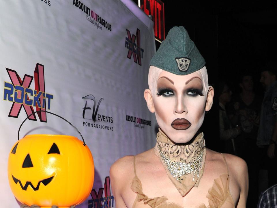 Sharon Needles holding a pumpkin trick or treat basket.