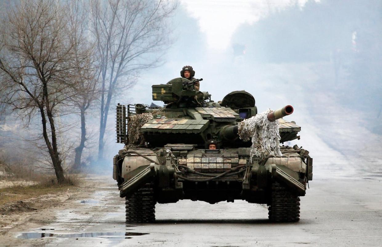 File photo: Ukrainian servicemen ride on tanks towards the front line with Russian forces in the Luhansk region of Ukraine on February 25, 2022.  (Anatolii Stepanov/AFP via Getty Images - image credit)