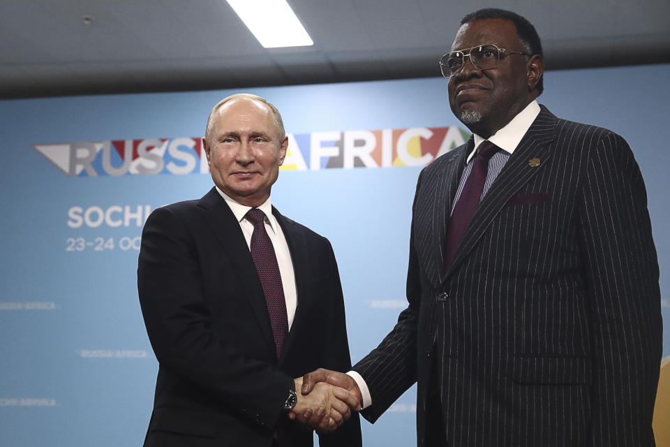 Russian President Vladimir Putin, left, and Namibia's President Hage Geingob shake hands prior to their talks on the sideline of Russia-Africa summit in the Black Sea resort of Sochi, Russia, Wednesday, Oct. 23, 2019. (Sergei Fadeyechev, TASS News Agency Pool Photo via AP)