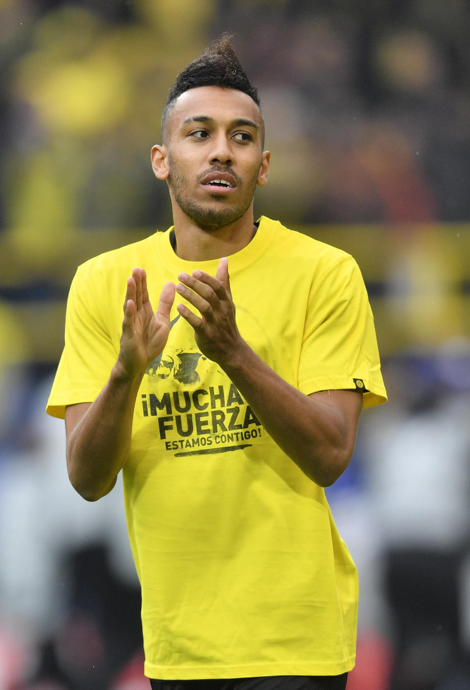 Dortmund's Pierre-Emerick Aubameyang wears a t-shirt 'A lot of strength - we are with you" for his teammate Marc Bartra who was injured after an explosion the day before as he warms up prior to the Champions League quarterfinal irst leg soccer match between Borussia Dortmund and AS Monaco in Dortmund, Germany, Wednesday, April 12, 2017. (AP Photo/Martin Meissner)