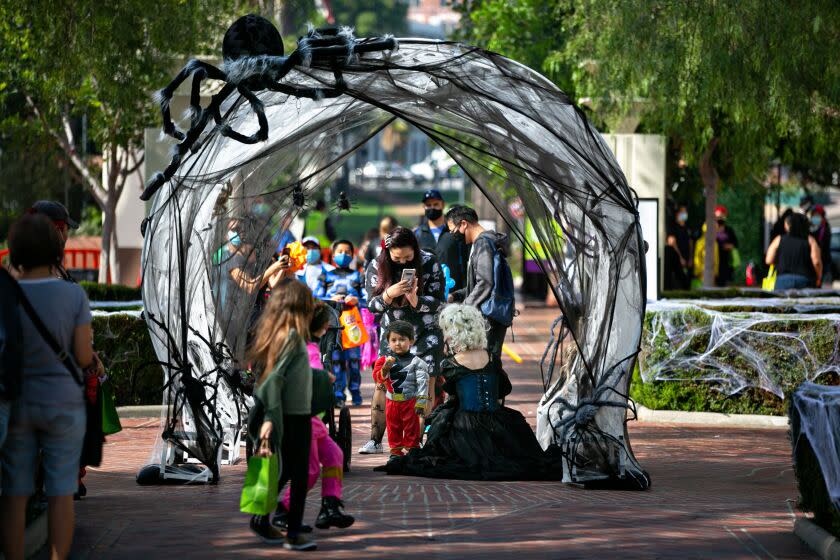 LOS ANGELES, CA - OCTOBER 30: Families walk down the spider web tunnel at the 3rd annual Boonion Station, a free, two-day, family-friendly Halloween hoopla at the iconic Union Station on Saturday, Oct. 30, 2021 in Los Angeles, CA. (Jason Armond / Los Angeles Times)