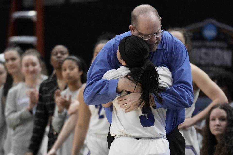 Christopher Newport head coach Bill Broderick hugs Gabbi San Diego during the second half of an NCAA Women's Division 3 championship basketball game against Transylvania Saturday, April 1, 2023, in Dallas. (AP Photo/Morry Gash)